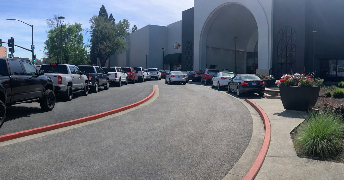 GPT-generated image of cars and driveway in front of the plaza