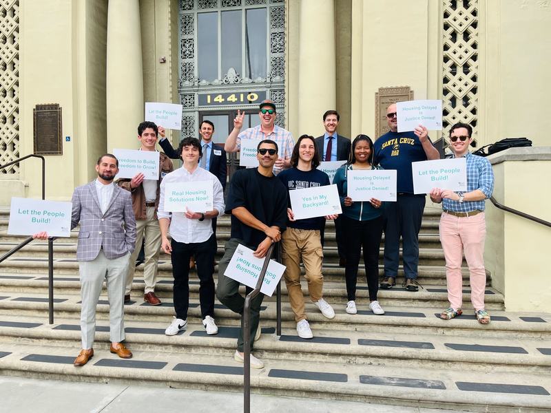 YIMBYs w/ signs on steps