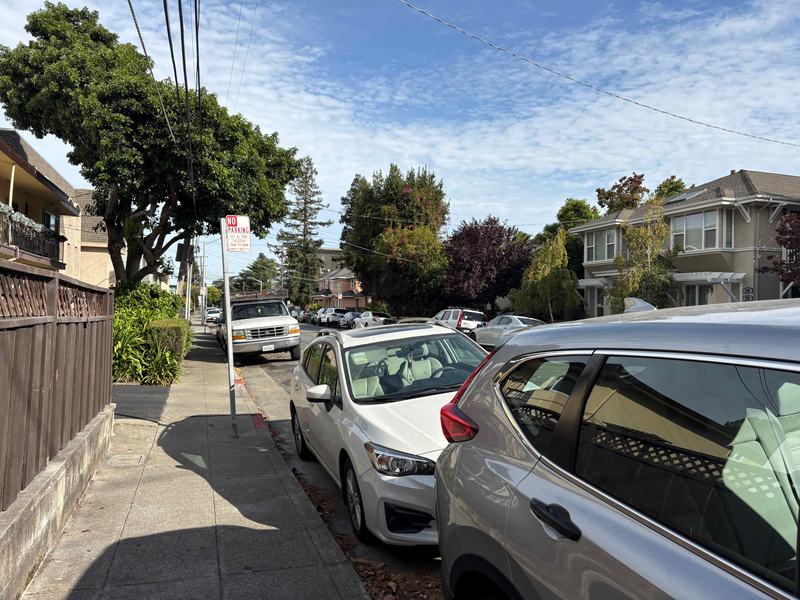 Cars parked along both curbs of N Ellsworth Avenue in San Mateo, with a street sweeping sign the only posted parking restriction