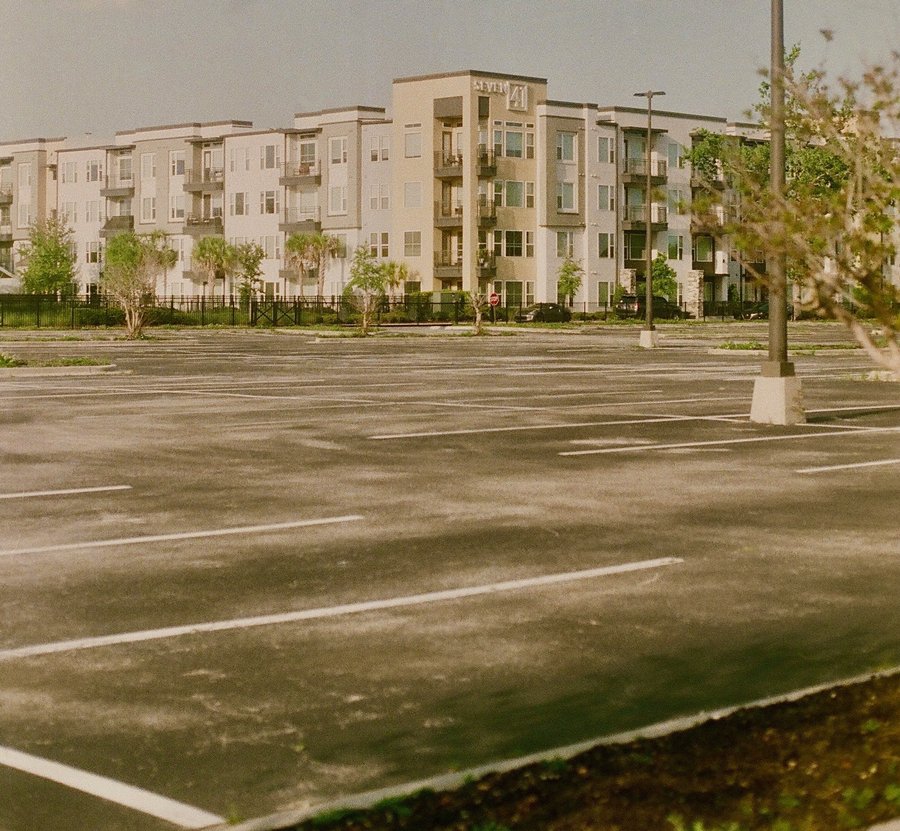 apartments with large empty parking lot